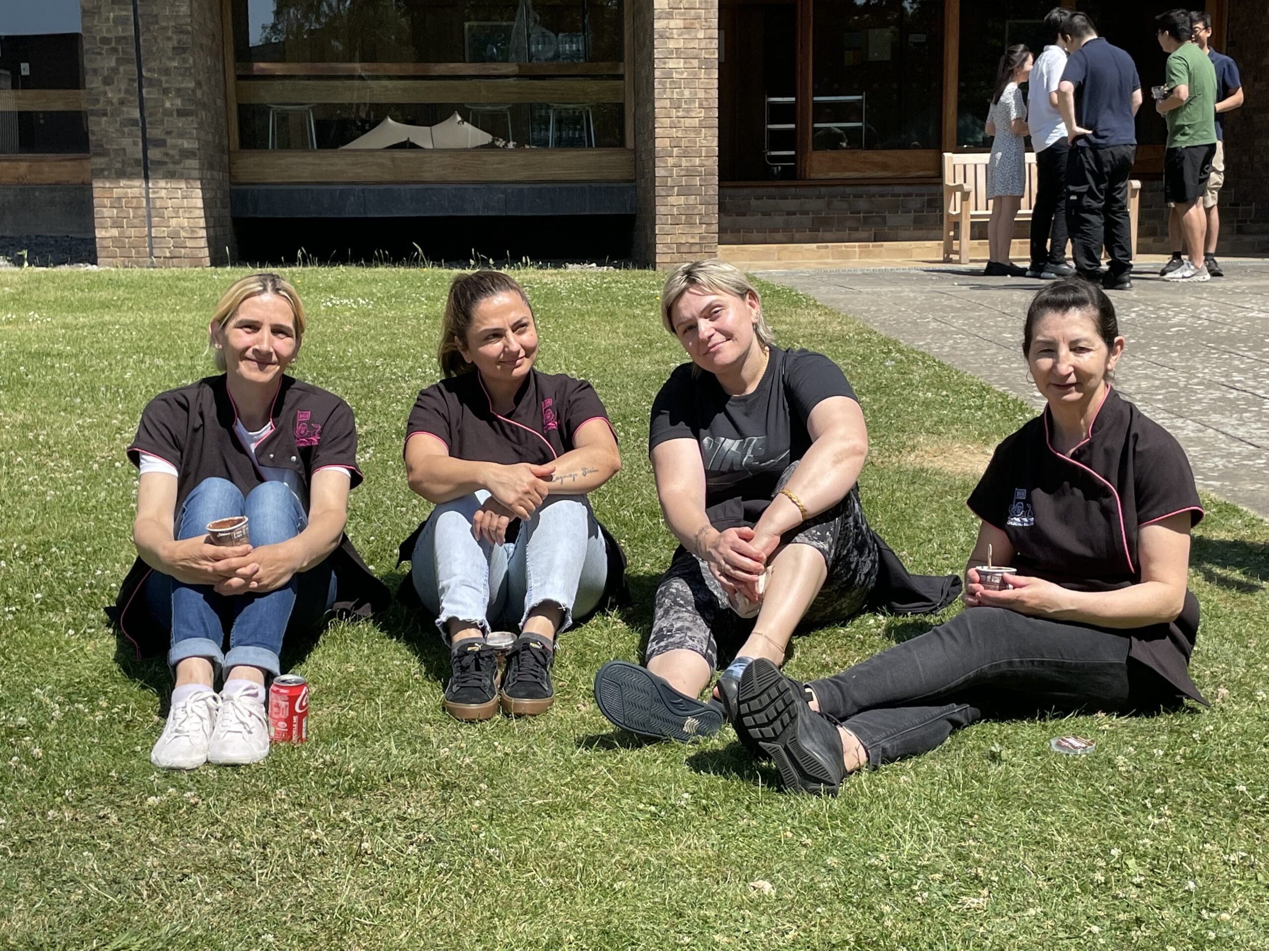 four members of Churchill staff sat on grass