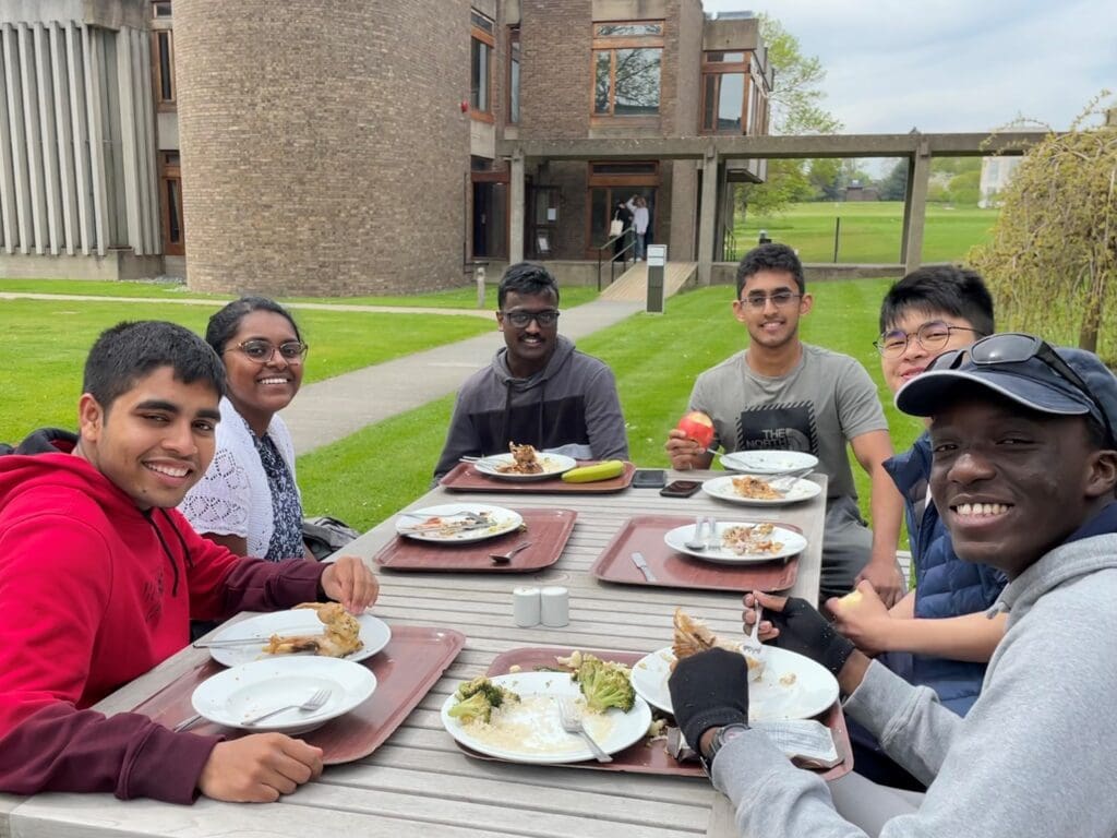 group of students sat around a table eating lunch