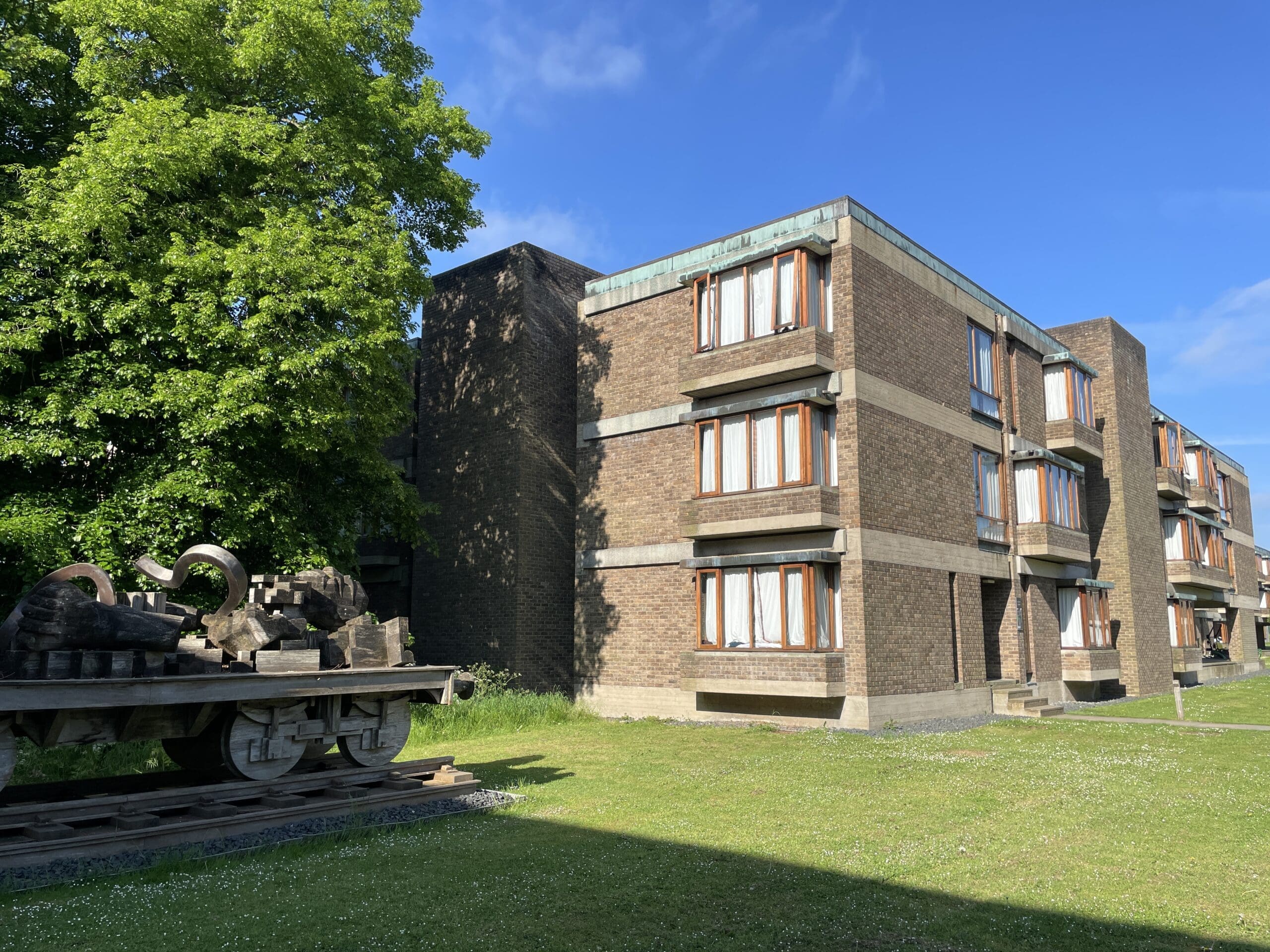 Exterior of South Court showing tree and sculpture in foreground