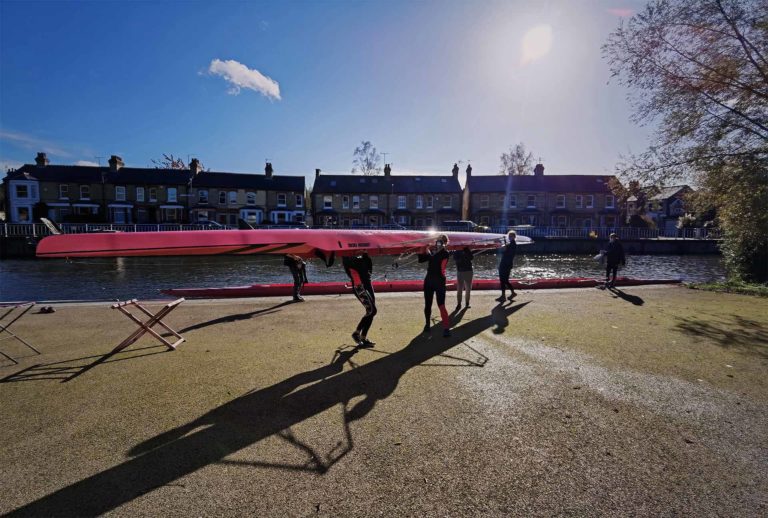 Churchill boat club members carrying a boat to the water