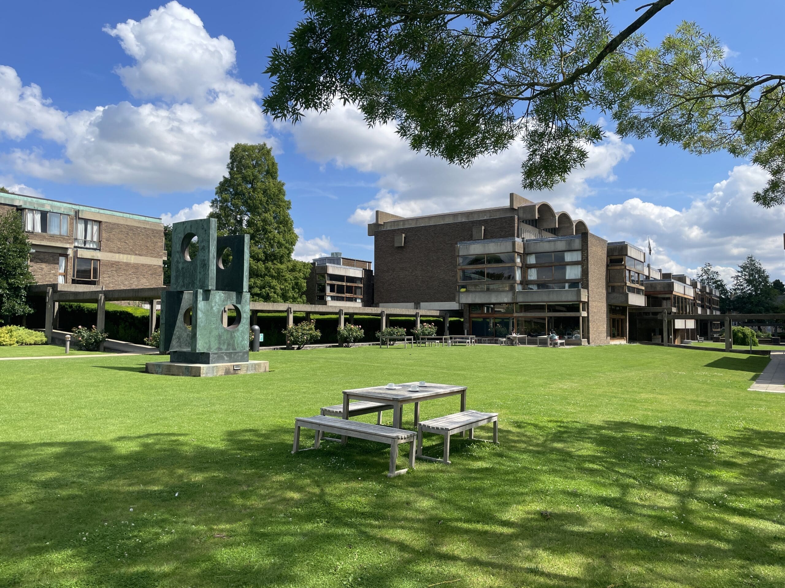 College grounds showing picnic table on grass, lawns and walkway