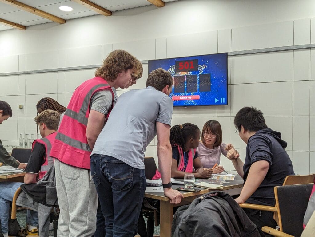 ACCEL course students working on a project around a table