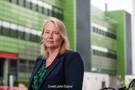 Professor Catherine Green in front of a green building